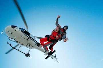 Skydiving tandem is jumping out of a helicopter