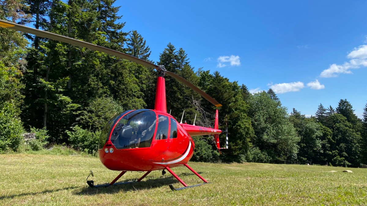 a small plane sitting on top of a grass covered field