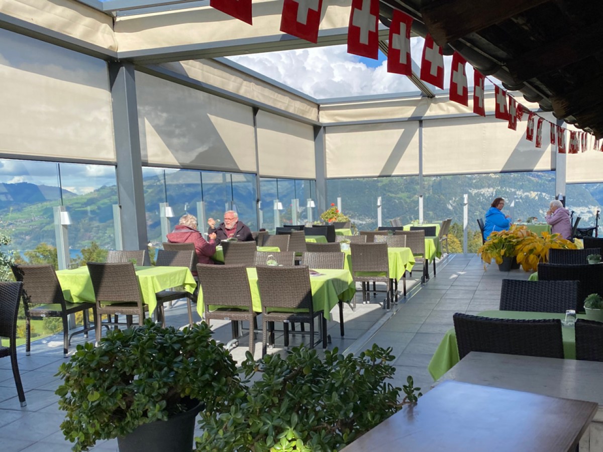 a group of people sitting at a table in front of a building