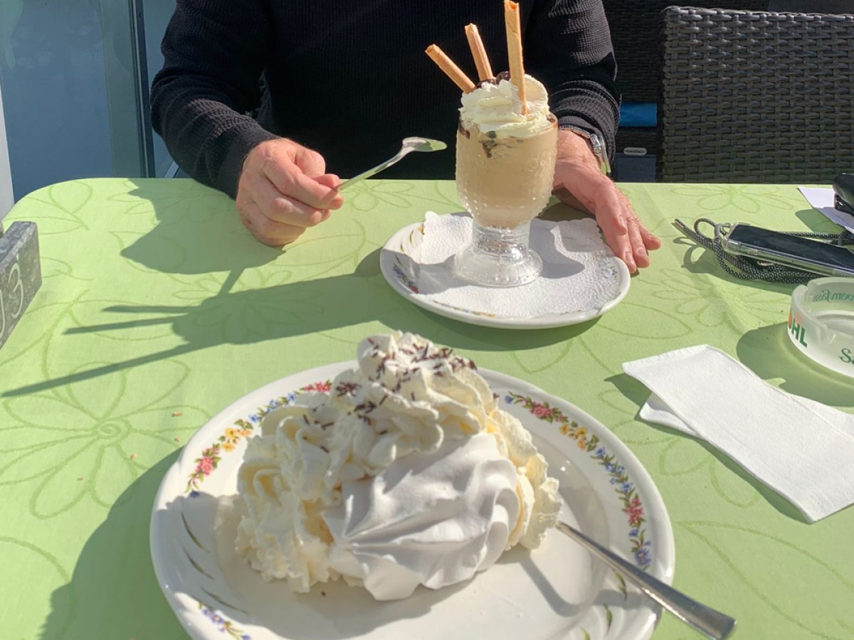 a woman sitting at a table with a cake on a plate