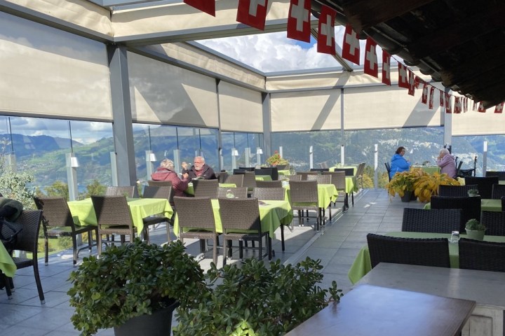 a group of people sitting at a table in front of a building